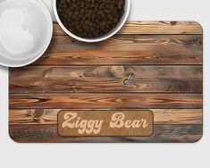 a bowl of dog food next to a wooden sign with the word ziggy bear on it