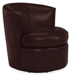 a brown leather chair sitting on top of a white floor