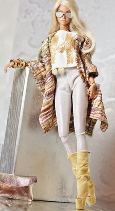 a barbie doll wearing white pants and boots