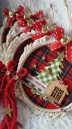 two christmas ornaments are sitting on some white fur