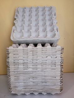 two wicker baskets stacked on top of each other with eggs in the bottom one is empty