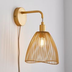 a light that is on the wall next to a white wall with a lamp attached