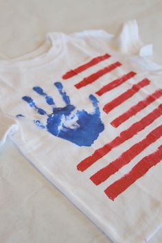 a t - shirt with the american flag painted on it is laying on a table