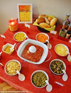 the table is full of different foods and condiments for a party or gathering