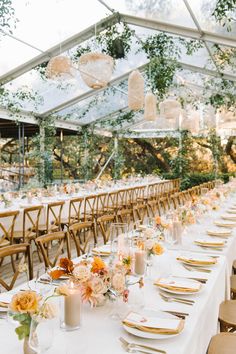 the tables are set for an outdoor wedding reception with white linens and gold chargers