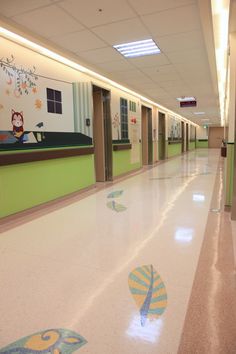 an empty hallway with green and white walls