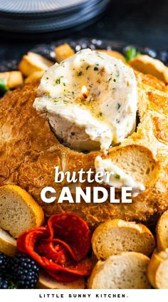 a close up of a plate of food with crackers and bread on it that says buttered candle