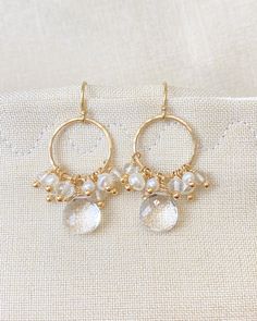 I created these earrings to be a pretty and versatile day-to-night style. The foundation of these earrings is gold-filled circles, which I lightly hammered for a subtle texture. Beautifully faceted, crystal quartz briolettes are suspended from the circles to anchor the design. These perfectly clear stones are then crowned with clusters of tiny freshwater pearls and more petite faceted crystal quartz beads. Enjoy wearing these brilliant stones in radiant gold fill with everything from jeans and s Hair Tricks, Pearl Cluster Earrings, Night Style, Pearl Cluster, Quartz Beads, Clear Stone, Fashion Night, Freshwater Cultured Pearls, Cluster Earrings