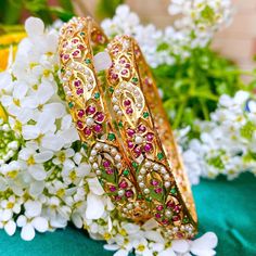 A pair of bangles made in 92.5 silver and embellished with freshwater pearls and synthetic rubies and emeralds. Exquisite craftsmanship and detail make these the ideal accessory for special occasions. Elevate your look with the timeless elegance of these beautiful bangles. Jadau Bangles, 22k Gold Jewelry Necklaces, Beautiful Bangles, Antique Gold Jewelry Indian, Indian Bridal Jewelry Sets, Antique Bridal Jewelry, Gold Jewelry Stores, Bangles Making, Wedding Jewellery Collection