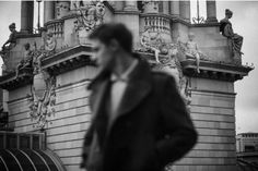 a man standing in front of a tall building