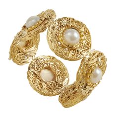 three gold rings with pearls on them