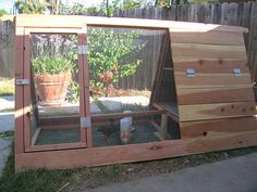 an outdoor chicken coop made out of wood