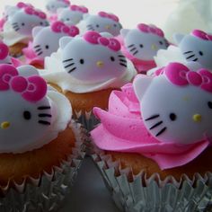 hello kitty cupcakes with pink frosting and bows on them are ready to be eaten