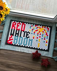 a board game sitting on top of a wooden table next to sunflowers and flowers