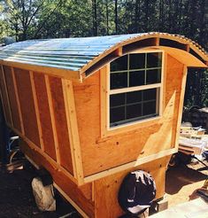 a small wooden building with a metal roof