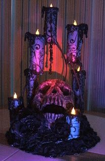 an elaborately decorated chair with candles in front of it and a skull on the back