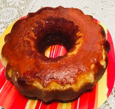 a donut sitting on top of a red and yellow plate