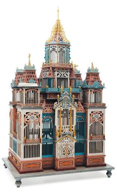 a wooden model of a building with many windows and arches on the front, including an ornate clock tower