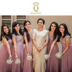 a group of women standing next to each other in long dresses and holding bouquets