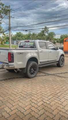 a white pick up truck parked in a parking lot