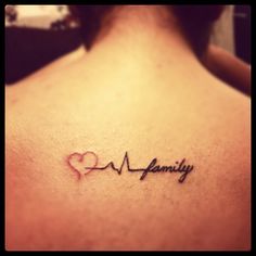 the back of a woman's neck with a heart and heartbeat tattoo on it