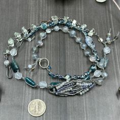 This incredible wrap bracelet has been a work in progress for a while. The combination of the pewter focal with the gorgeous 6mm flashy labradorite rounds absolutely enchanted me. From there, I added so many of my favorite things. In this bracelet, you’ll find apatite rectangles, the most insane faceted 8mm kyanite, 8mm starcut pale jade, flashy tourmilinated rainbow moonstone, smoky quartz, and the most incredible faceted prasiolite nuggets. Also featured are the prettiest faceted glass rondelles. Let’s circle back to the focal. The shape was so interesting and mysterious to me. I wrapped on faceted labradorite and iolite to bring out some of the lines. This wrap bracelet is sterling silver, with the exception of the USA made pewter focal. The knotted portion of the bracelet was done in h Spiritual Wire Wrapped Bracelet With Round Beads, Handmade Silver Wrap Bracelet For Healing, Handmade Spiritual Silver Wrap Bracelet, Silver Wrap Bracelet With Round Natural Stones, Hand Wrapped Labradorite Bead Jewelry, Handmade Silver Spiritual Wrap Bracelet, Handmade Silver Multi-strand Wrap Bracelet, Bohemian Multi-stone Adjustable Bracelets, Bohemian Multi-strand Gemstone Beads Bracelets