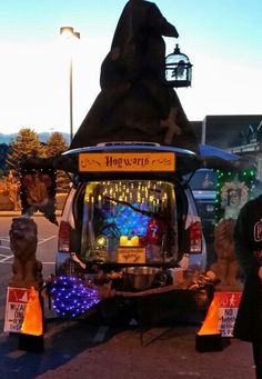 a man standing next to a vehicle decorated with lights