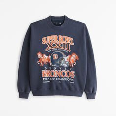 Elevate your game day attire with the Men's Denver Broncos Graphic Crew Sweatshirt from Abercrombie & Fitch. This piece combines comfort with spirited style, perfect for any Broncos fan.

- Size: XL TALL
- Color: Sapphire
- Material: Cotton, Polyester blend
- Gender: Male
- Features: Crew neckline, banded hem and cuffs, Denver Broncos graphic on chest

Crafted in our exclusive softAF fleece fabric, this sweatshirt offers an oversized fit that ensures ease and mobility. Whether you're at the stad Male Features, Broncos Fans, Classic Sweatshirt, Men's Tops, Denver Broncos, Philadelphia Eagles, Crew Sweatshirts, Fleece Fabric, Game Day