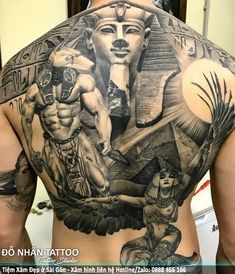 the back of a man's body with tattoos on it and an egyptian theme