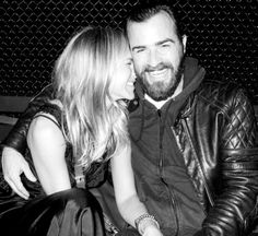 a man and woman sitting on top of a bench next to each other in black and white