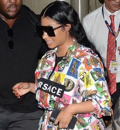 a woman in a colorful shirt and sunglasses