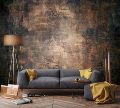 a grey couch sitting on top of a wooden floor next to a lamp and table