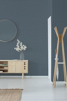 a modern living room with blue wallpaper and white flooring, including a wooden sideboard