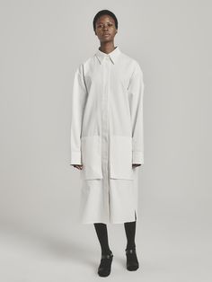 UNI FORM’s founder Luke Radloff designs timeless wardrobe staples you’ll want to wear for years to come. A shirt style that looks just as chic as a dress as it will as a light coat, this versatile number has an oversized fit with dropped shoulders, a storm flap-style overlay, and practical pockets. It’s been locally made in South Africa from pure cotton. Wear it with chunky sandals and silver jewelry. - Classic collar, concealed button fastening, long sleeves with extended cuffs, storm flap, poc African Luxury, Jewelry Classic, Timeless Wardrobe, Timeless Wardrobe Staples, Light Coat, Chunky Sandals, A Storm, White Cotton, Wardrobe Staples