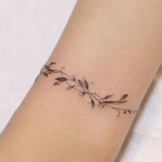 a woman's arm with a small tattoo on the left side of her wrist