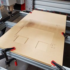 a machine that is cutting out a piece of cardboard