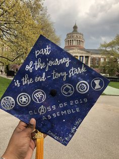 a person holding up a graduation cap that says part of the journey is the end - tony starke