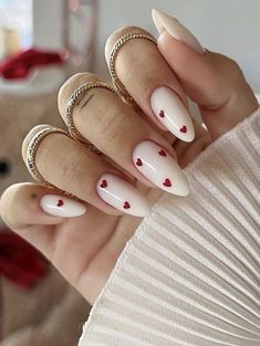 24-Piece Almond Press-On Nails set in White with Small Red Hearts, a stunning blend of sophistication and style that promises to elevate your look effortlessly. Featuring an exquisite almond shape and adorable small red hearts, these press-on nails serve as the ultimate eye-catching accessory, perfect for those who crave a unique twist on the go! What's Included: * FULL SET (24 nails): A meticulously crafted collection of almond-shaped nails, each adorned in classic white with charming small red Spring Manicure, February Nails, Her Nails, Red Nail, Nail Swag, Spring Nail, Heart Nails, Valentine's Day Nails