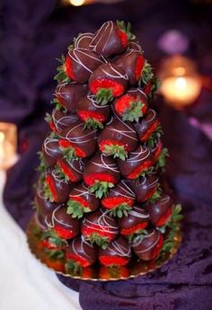 chocolate covered strawberries stacked on top of each other in the shape of a christmas tree