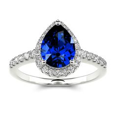 a blue sapphire and diamond ring with white diamonds on the band, set in 18k white gold