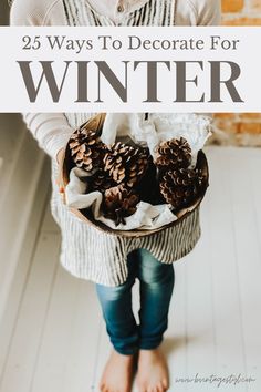 a girl holding a basket full of pine cones with the words 25 ways to decorate for winter