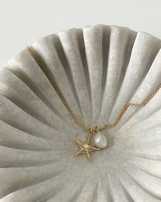 "Gold/Rose Tone pieces are NOT solid 14K gold! Silver pieces ARE solid 925 sterling silver :) Expand below for all the 'deets'... From the Oceane Collection by Jorie Breonn THE OCEANE COLLECTION 1.  Organic Sea Shell : https://www.etsy.com/listing/1449385231 2.  Sea Coral with Pearl : https://www.etsy.com/listing/1461473368 3.  Sea Urchin : https://www.etsy.com/listing/1461324578 4.  Twist Sea Shell : Etsy Listing Coming Soon! 5.  Starfish with Pearl : https://www.etsy.com/listing/1475464611 6.  Conch Sea Shell : Etsy Listing Coming Soon! 7.  Snail Shell : Etsy Listing Coming Soon! 8.  Spiral Sea Shell : Etsy Listing Coming Soon! 9.  Sand Dollar : https://www.etsy.com/listing/1475667475 10.  Shark Tooth : Etsy Listing Coming Soon! 11.  Oyster Sea Shell : Etsy Listing Coming Soon! 12.  Clam Dainty Gold Starfish Necklace, Gold Starfish Shaped Dainty Jewelry, Dainty Starfish Gold Jewelry, Minimalist Gold Jewelry With Starfish Charm, Dainty Gold Starfish Jewelry, Minimalist Starfish Charm Jewelry, Delicate White Jewelry With Star Charm, Pendant Minimalist, Snail Shell