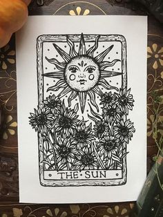 the sun tarot card surrounded by flowers