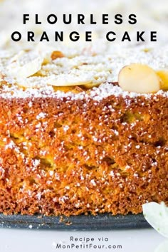 an orange cake with powdered sugar on top