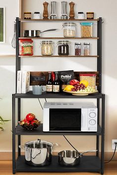 a microwave oven sitting on top of a metal shelf next to pots and pans