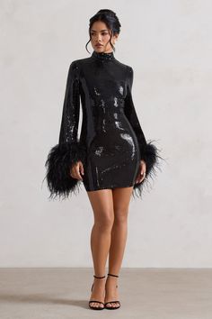 A dress you're sure to fall in love with, meet our aptly-named mini Cupid. Carefully crafted in a bodycon silhouette of light-catching sequins, this LBD is detailed by its demure high neckline, long sleeves and dramatic feather-trimmed cuffs. Keep Cupid at the forefront of your next party and pair yours with some simple strappy stilettos. Features - Premium sequin- Bodycon fit - High neckline - Long sleeves- Feather cuffs- Invisible zip closure- Mini length Sizing & Fit Model is 5'6 and wears UK size 8 / US size 4 Product Information Designed exclusively by Club L London Lined with some stretch Premium sequin in Black (100% Polyester) Premium stretch satin (95% Polyester, 5% Elastane)Trim (100% Real Feathers)85cm total length SKU: CL134605002 Product CareTo prolong the life of your feather Feather Cuffs, Club L London, High Neck Mini Dress, Strappy Stilettos, Information Design, Invisible Zip, Glam Dresses, Stretch Satin, Black Sequins