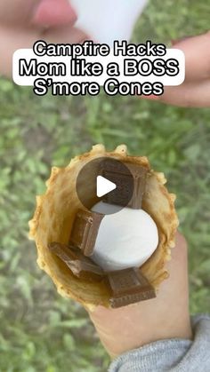 someone is holding up a piece of food with marshmallows in it and the caption reads campfire hacks mom like a boss's smore cones