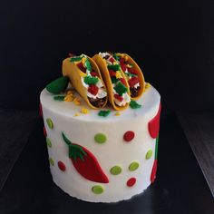 two tacos on top of a decorated cake