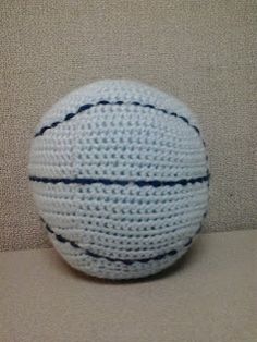 a crocheted white ball sitting on top of a table next to a wall