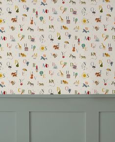 the wall paper has animals and letters on it